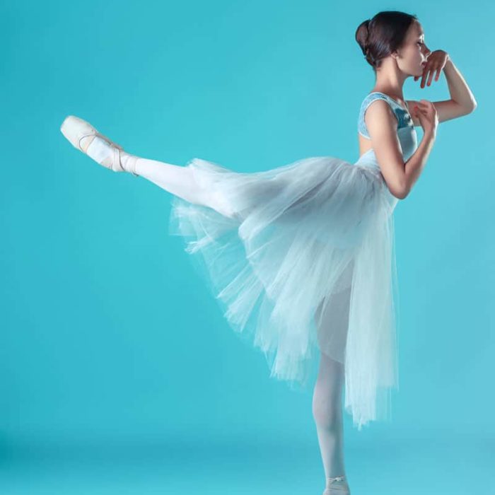 ballerina in white dress posing on toes studio PA9XMNQ from The Plus Addons for Elementor