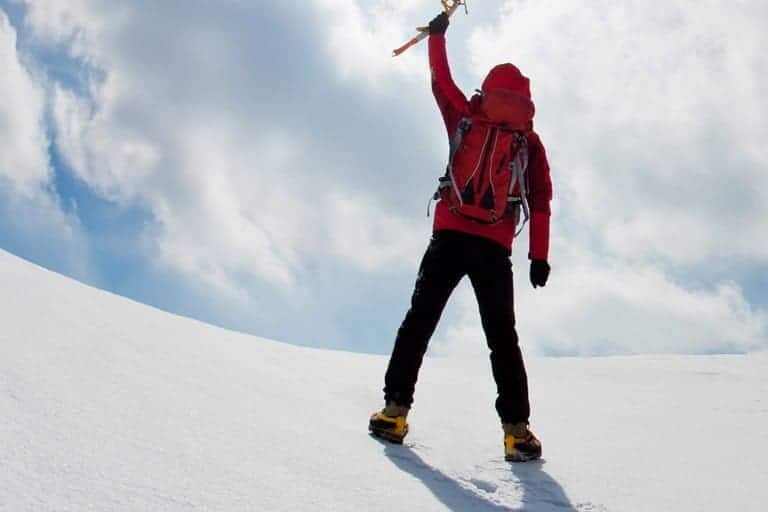 mountaineer walking uphill along a snowy slope3 1 The Plus Addons for Elementor