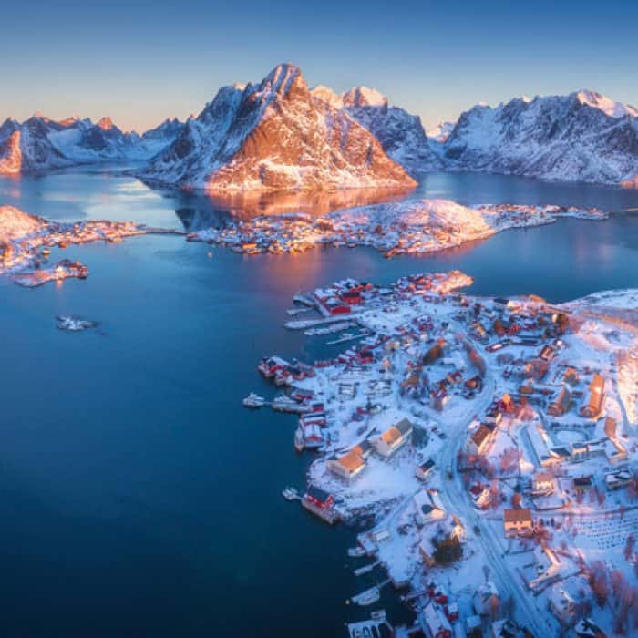 aerial view of reine at sunrise in winter in S9ACL35 Carousel Active background from The Plus Addons for Elementor