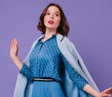 Emotional brunette woman blue coat posing purple wall indoor photo beautiful short haired female model trendy midi dress 1 accordion from the plus addons for elementor